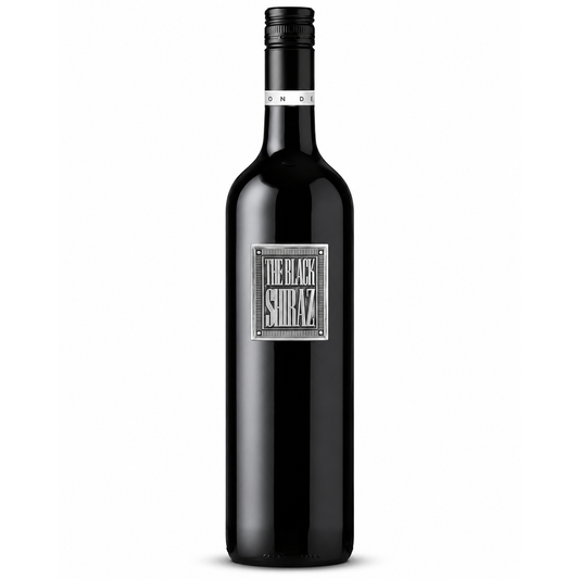A bottle of Black Shiraz red wine with a black glass body, black screw cap, and a silver rectangular label reading 'THE BLACK SHIRAZ'.