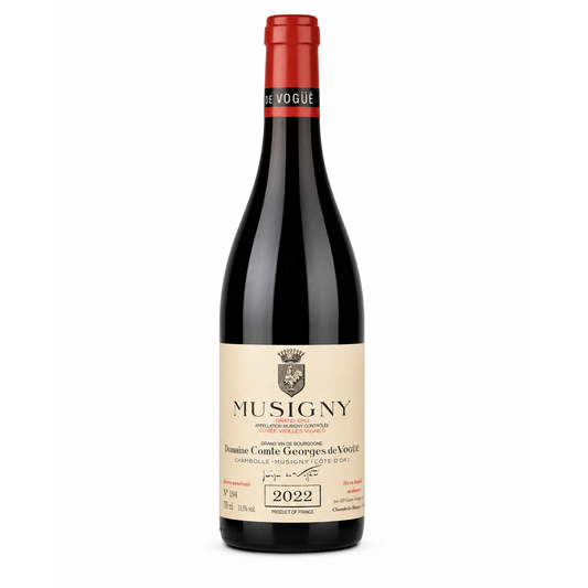 A bottle of Musigny red wine from Domaine Comte Georges de Violette, featuring a dark glass bottle, a cream-colored label with black text, and a red foil capsule at the top, set against a plain white background.