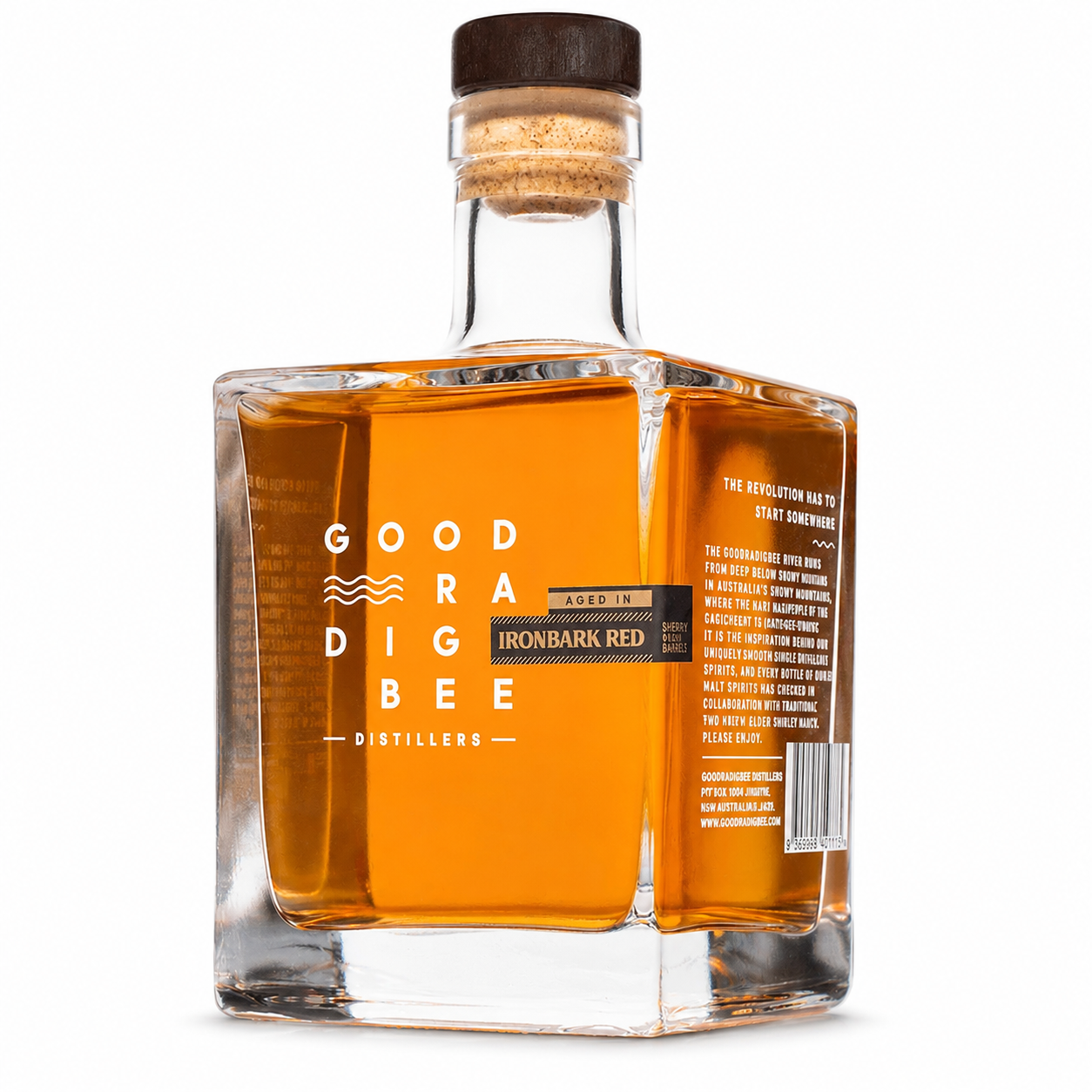 A square glass bottle of Good Radig Bee Distillers 'Ironbark Red' bourbon whiskey, showing the amber liquid inside, a cork stopper, and both the front and back labels against a white background.
