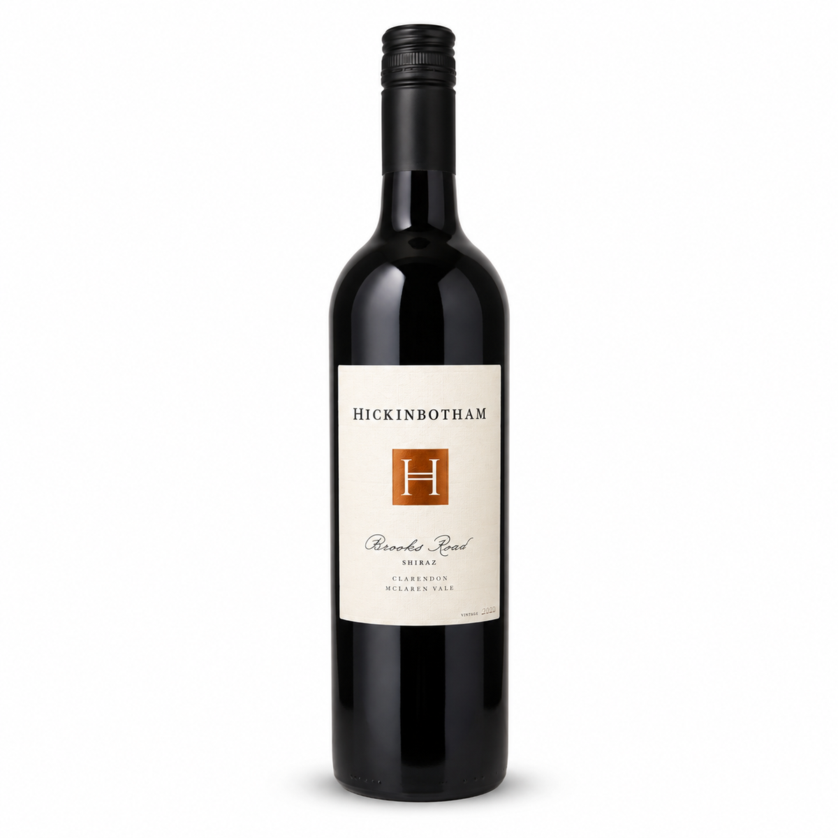 A bottle of Hickinbotham Brooks Roead 2023 Shiraz from the Clarendon McLaren Vale Region, featuring a black glass bottle, black screw cap, and a cream-colored label with a brown 'H' logo, set against a off white background.