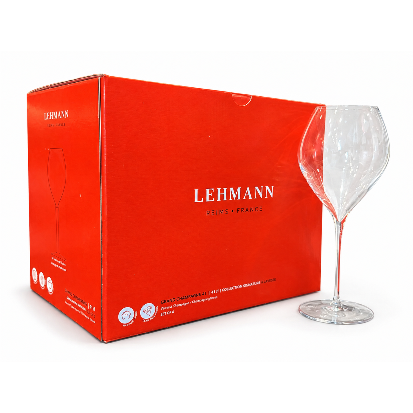 A clear Lehmann wine glass standing next to its bright red cardboard packaging box on a white background.
