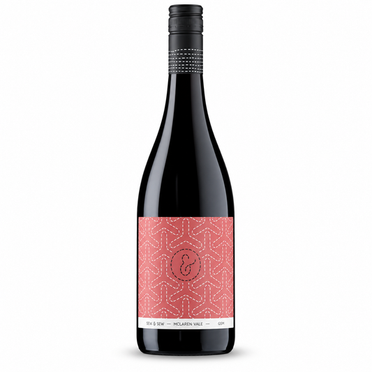 A bottle of Sew & Sew GSM, a dark red wine bottle with a black cap and a coral pink patterned label. 