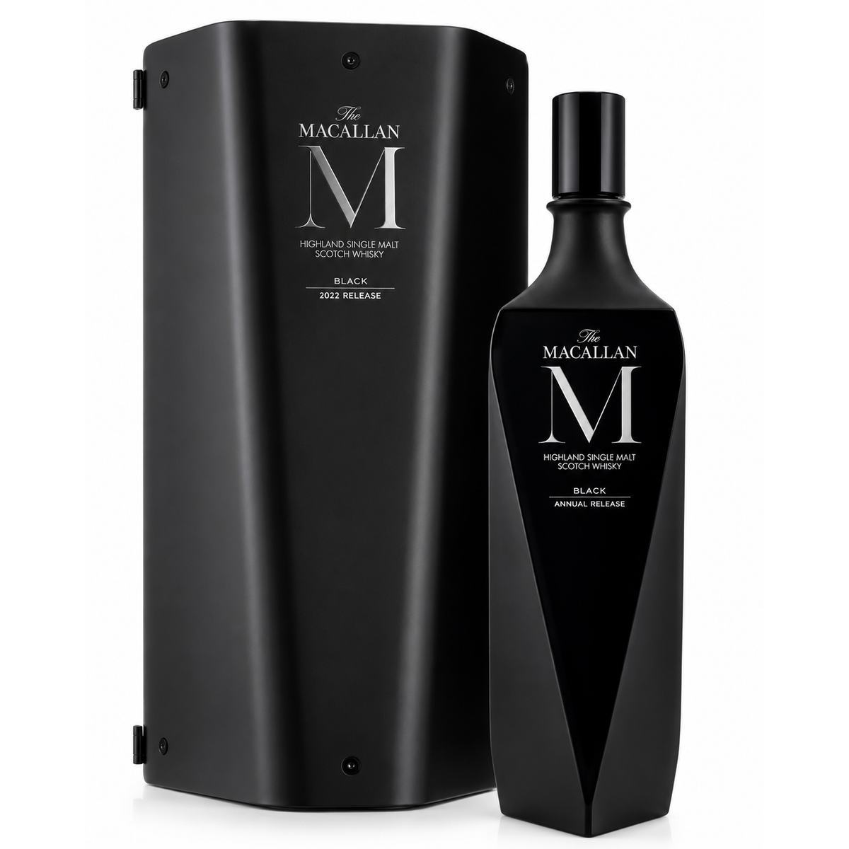 The Macallan M Black Annual Release Scotch whisky bottle next to its matching black presentation box, featuring a large silver 'M' logo and white text on a clean white background.