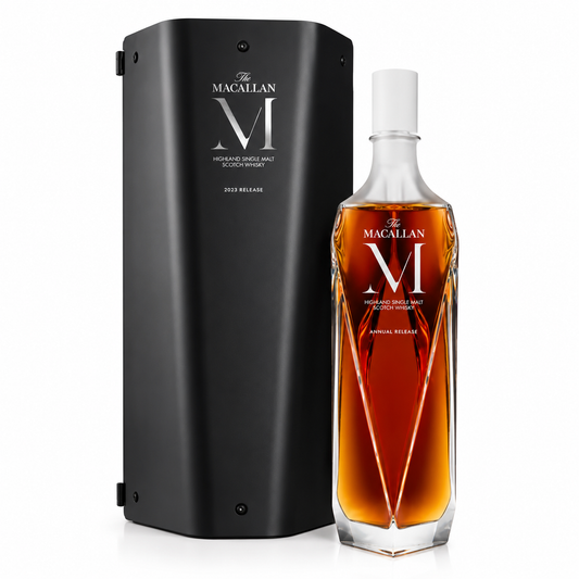 A bottle of Macallan Single Malt Scotch Whisky with amber liquid and a white cap, displayed beside its tall black presentation box on a clean white background.